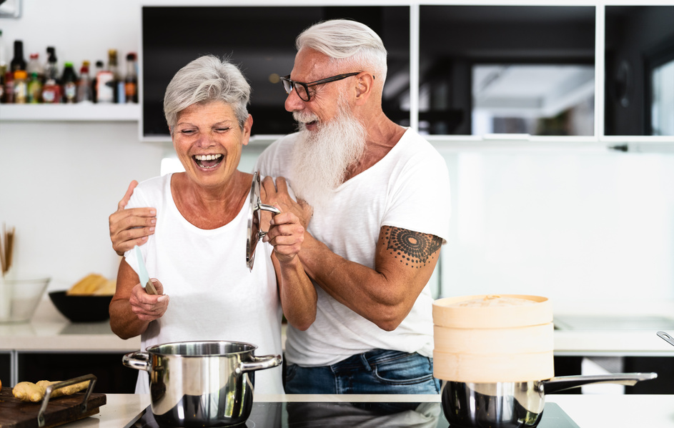 Happy Couple Having Fun while Cooking at Home Kitchen